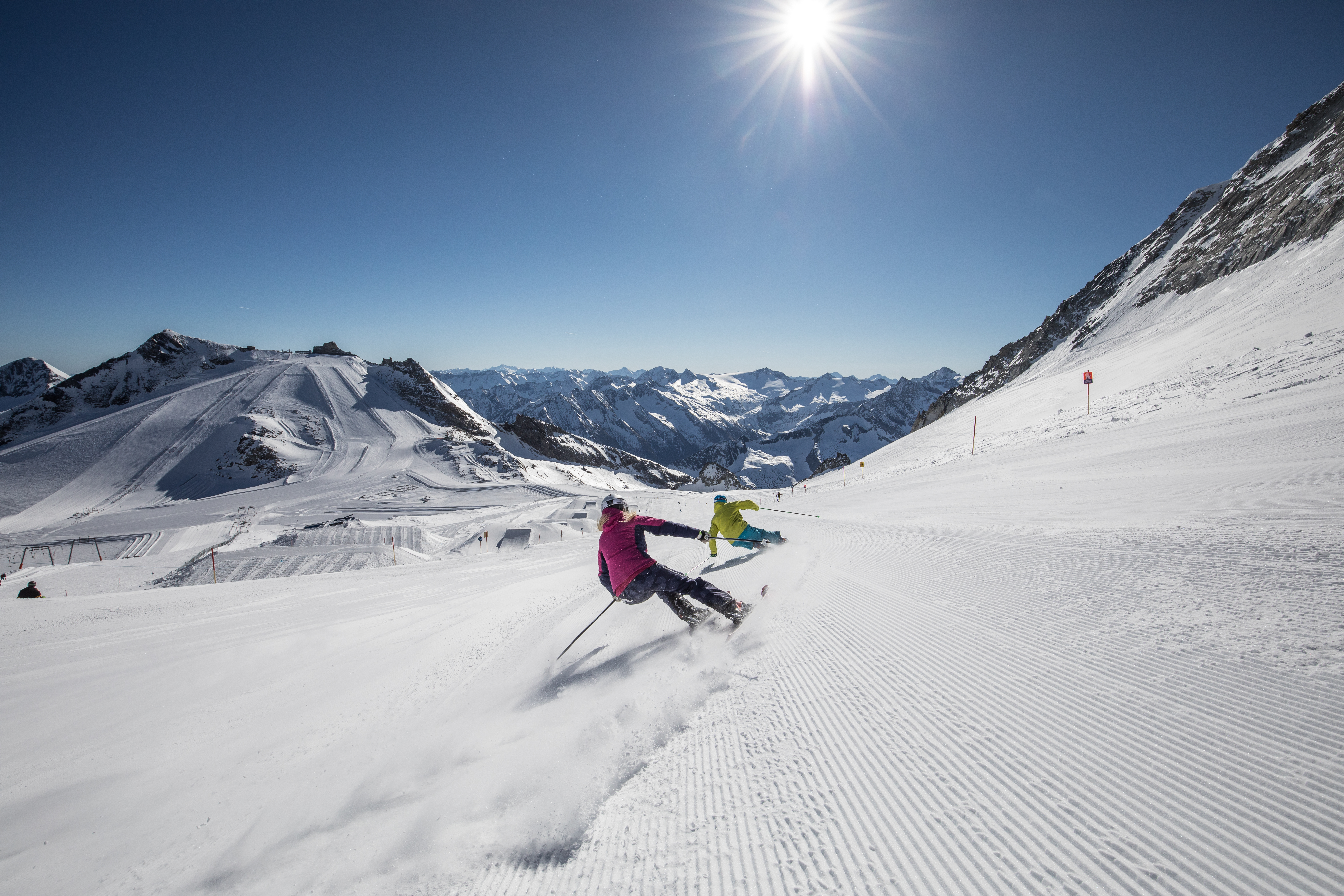 zwei Skifahrerinnen carven auf der Piste